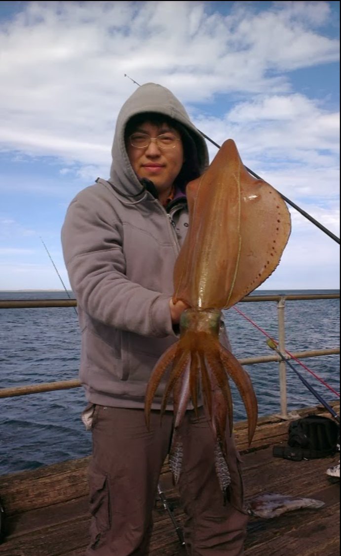 Rui holding a large Southern Calamari at Flinders Pier, Victoria, in 2011