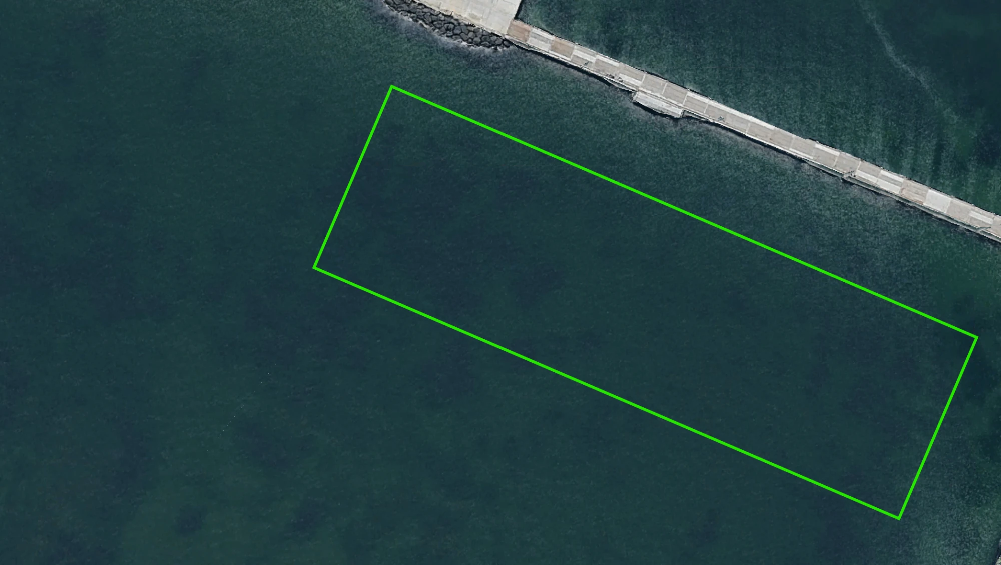 Satellite view of the Brighton breakwall with a marked zone of open water off the rocks and the concrete pier section running to the top right