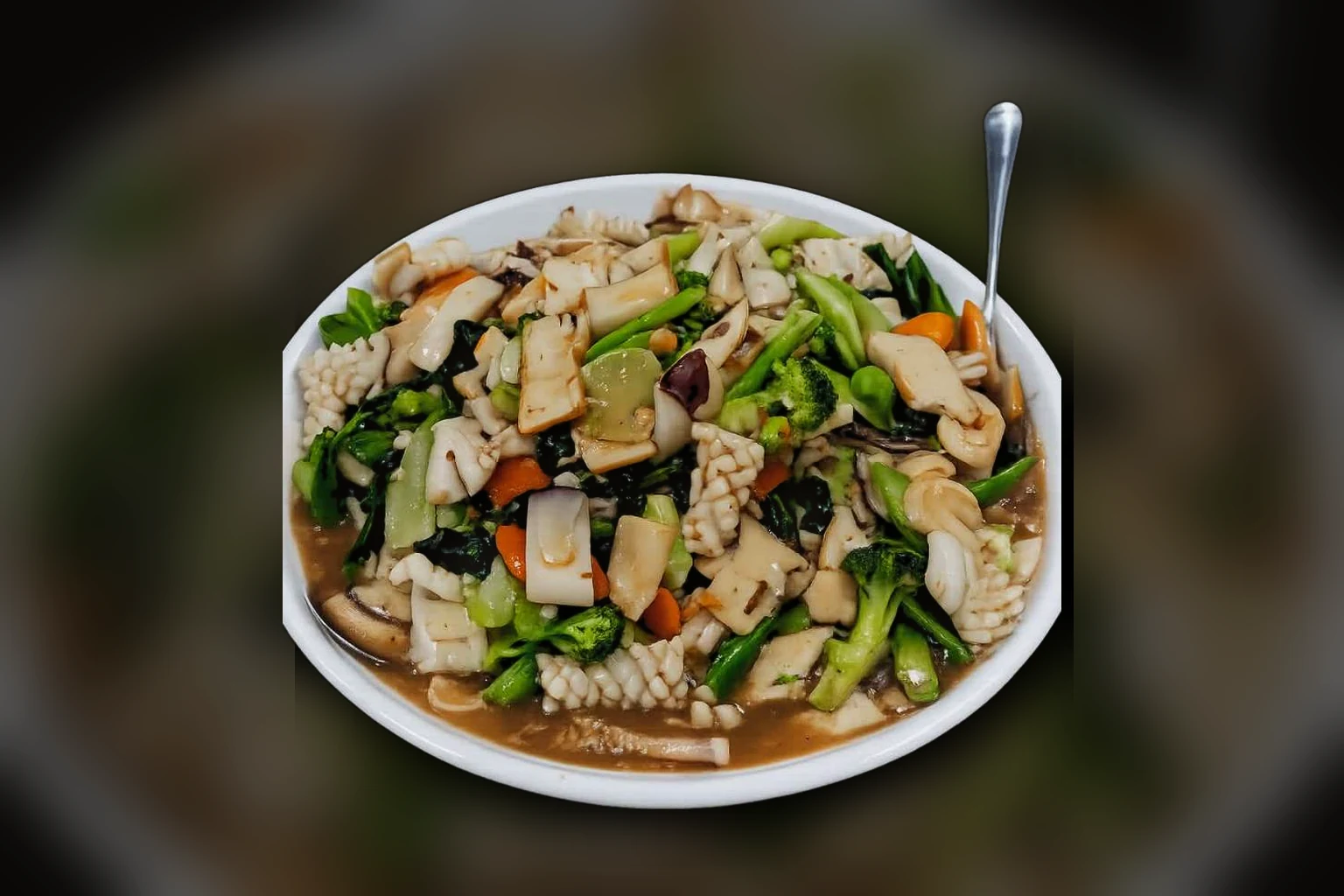 Cantonese squid and prawn stir-fry with broccoli, gai lan, carrot, mushrooms and fried tofu in oyster sauce gravy